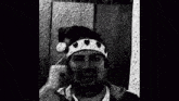 a black and white photo of a man wearing a t-shirt that says `` arabic '' .