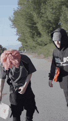 a man wearing a hoodie that says ' skeletons ' on it