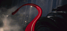 a close up of a person 's leg with a red ribbon around it .