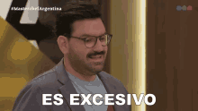 a man with glasses and a beard says " es excesivo " in spanish