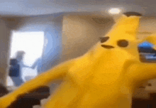 a person dressed as a banana is standing in a living room .