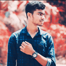 a young man in a plaid shirt is wearing a watch
