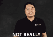 a man wearing a black shirt that says freedom on it says not really