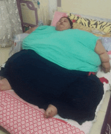 a very fat woman laying on a bed with a zebra print pillow