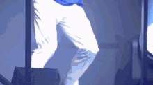 a person wearing white pants and a blue shirt is dancing