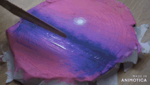 a pink and purple circle with the words made in animotica on the bottom