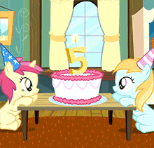 two ponies are celebrating a 5th birthday with a cake and candle