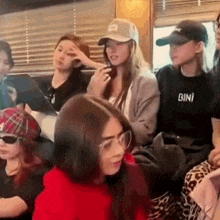 a group of young women are sitting next to each other on a couch .