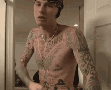 a shirtless man with a bandana on his head has a tattoo on his chest that says 1990