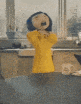 a cartoon doll is standing on a table with her mouth open