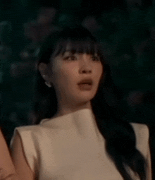 a close up of a woman 's face with her mouth open and a surprised look on her face .