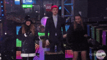 a crowd of people are gathered in a dark room with a sign that says oh call me yes !