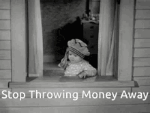 baby throwing money out windw