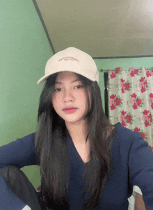 a girl wearing a white hat that says ' boston ' on the front