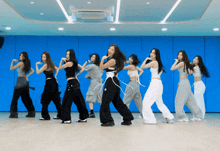 a group of young women are dancing in a dance studio