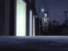 a man in a suit and tie is standing in front of a building at night