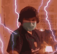 a person wearing a mask and headphones is standing in front of a lightning storm .