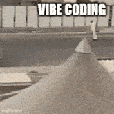 a black and white photo of a cone with the words vibe coding written on it .