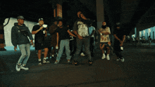 a man wearing a shirt that says hellstar stands in a crowd of people