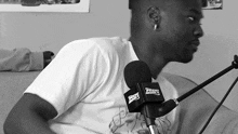 a man is sitting in front of a microphone that says pop radio