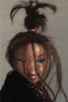 a doll with a bun in her hair and a ponytail