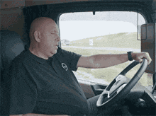a man is sitting in the driver 's seat of a truck