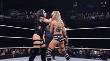 two women are wrestling in a ring with the word win on the bottom