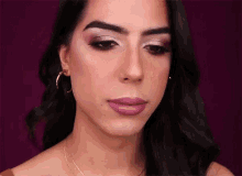 a close up of a woman 's face with purple lips