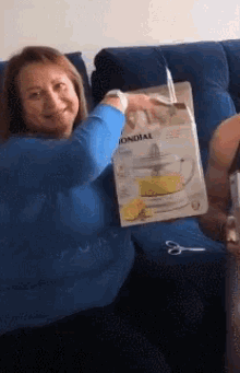 a woman in a blue shirt is holding a bag that says mondial
