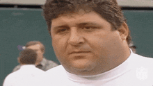 a man wearing a white shirt with the nfl logo on it