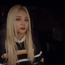 a woman with blonde hair looks up next to a form that says education