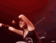 a woman wearing a black tank top that says peace