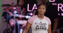 a woman wearing a shirt that says " a fucking black barbie "
