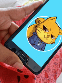 a person is holding a phone with a cat on the screen