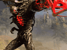 a monster with red eyes is holding a red object in its hand