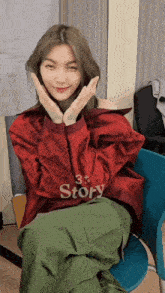 a woman wearing a red jacket that says story
