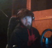 a man with a beard wearing headphones and a nike shirt
