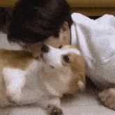a man is laying on the floor with a dog and the word oh is on the bottom right