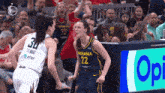 a basketball player with the number 22 on her jersey is celebrating