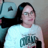 a woman wearing glasses and a creepy stuff happens t-shirt