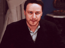a man with a beard wearing a suit and striped shirt