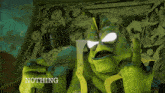 a green monster holding a microphone and a piece of paper that says nothing on it