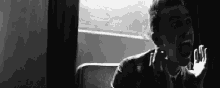 a black and white photo of a man screaming in a room .