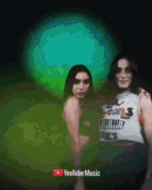 two women are posing for a picture with a youtube music logo in the corner