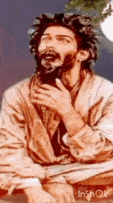 a man with a beard is sitting down with his hands on his chest and his eyes closed .