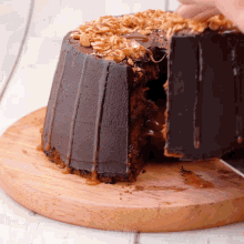a chocolate cake with nuts on top is cut in half