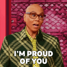 a bald man with glasses and a plaid jacket says i 'm proud of you