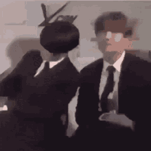 a blurry photo of two men in suits and ties