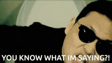 a man wearing sunglasses says " you know what i 'm saying "