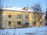 a yellow building with snow on the roof and the words minimaxel on the bottom right